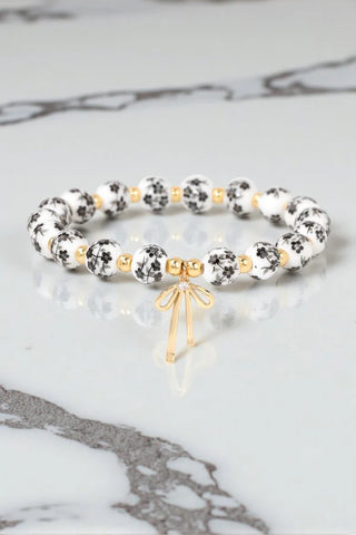 Floral beaded bracelet with bow charm