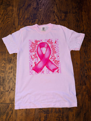 Ivory graphic tee with a pink breast cancer awareness ribbon design.