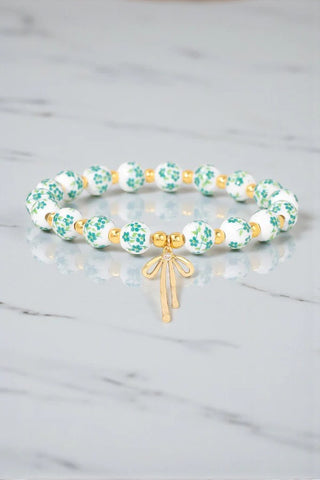 Floral beaded bracelet with bow charm