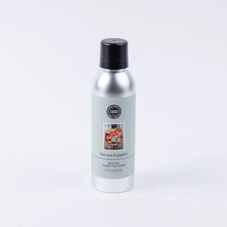 A 7 oz bottle of Harvest Pumpkin Room Spray with a label featuring a pumpkin image.