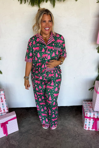 Green and pink pajama set with Christmas motifs and cheetah pattern.