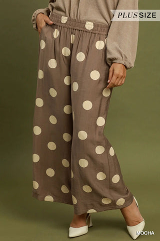 Mocha brown wide leg crop pants with large polka dots, featuring an elastic waistband and side pockets.